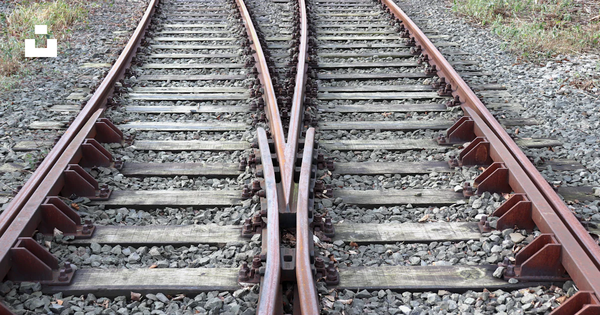 A set of train tracks in the middle of a field photo – Free Railway ...