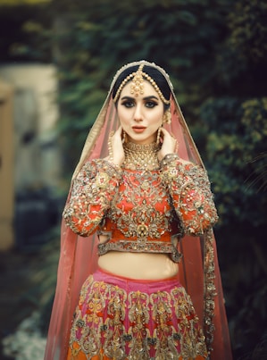 A woman in a red and gold bridal outfit