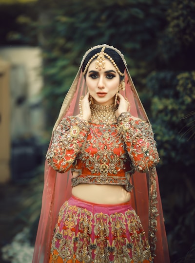 A woman in a red and gold bridal outfit