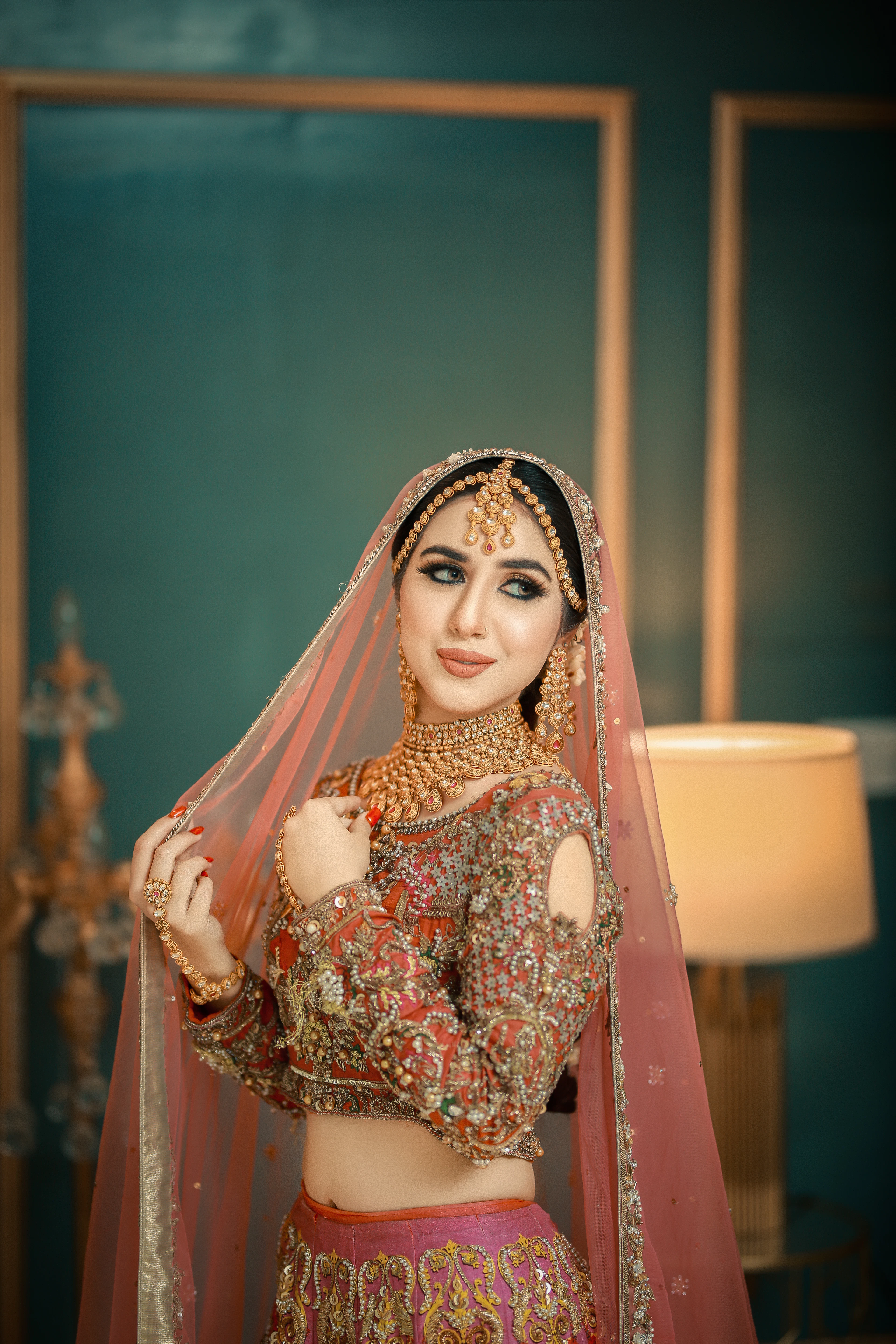 Bride in a soft-toned lehenga in a warm room