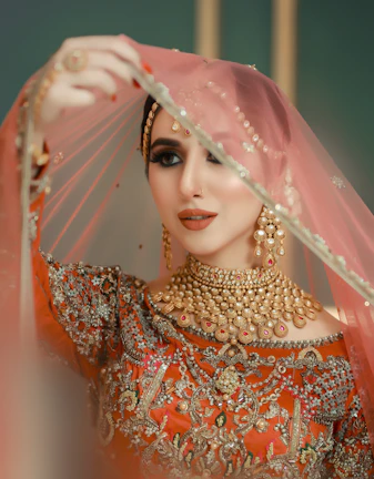 A woman in a red and gold bridal outfit