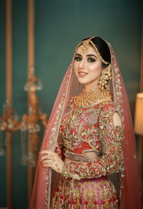 A woman in a red and gold bridal outfit