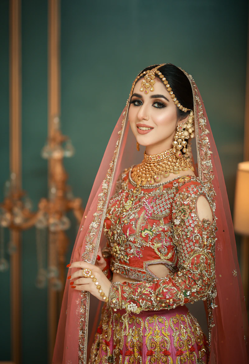 Bride in red and gold baraat outfit
