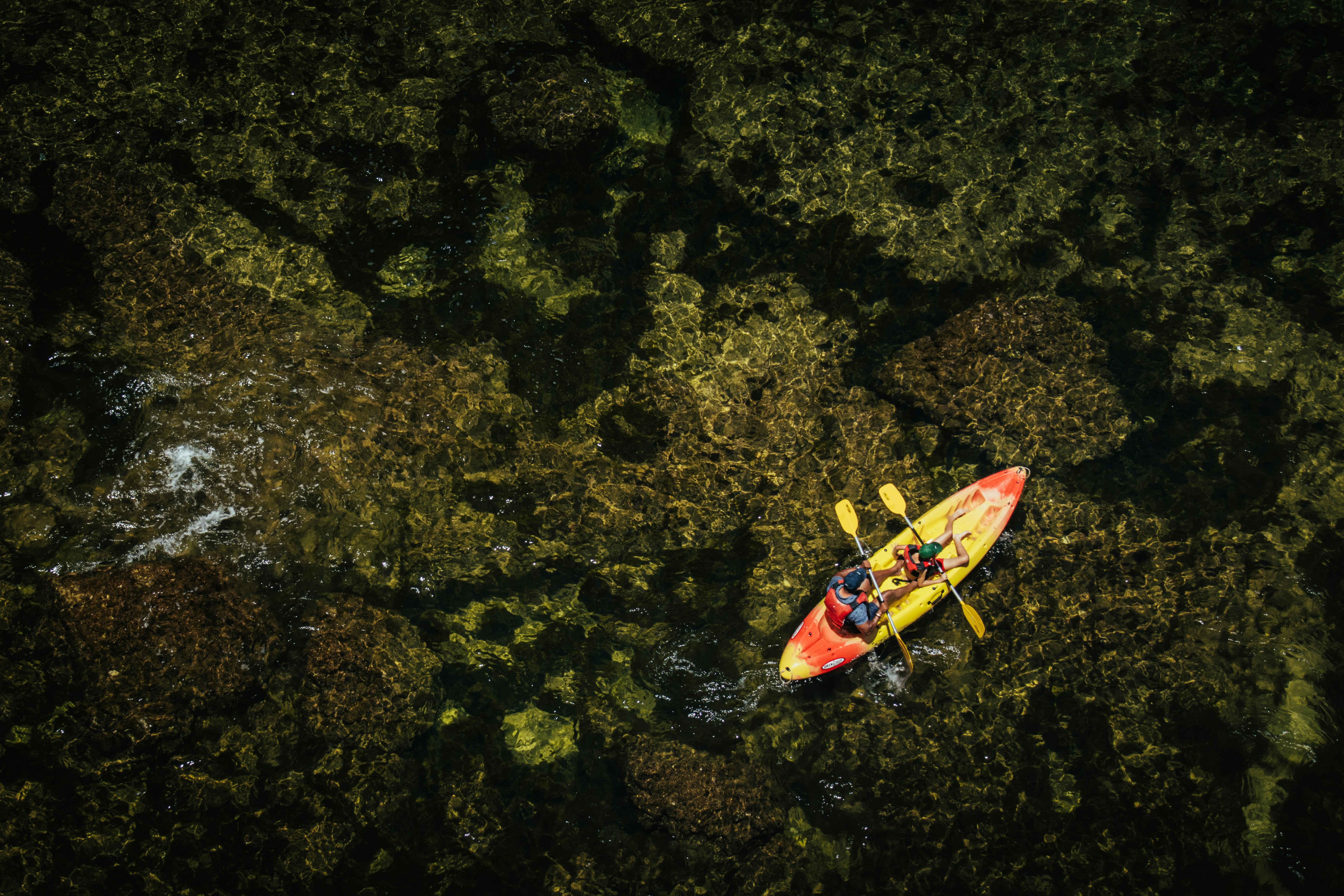 An aerial view of a kayak in the water, 