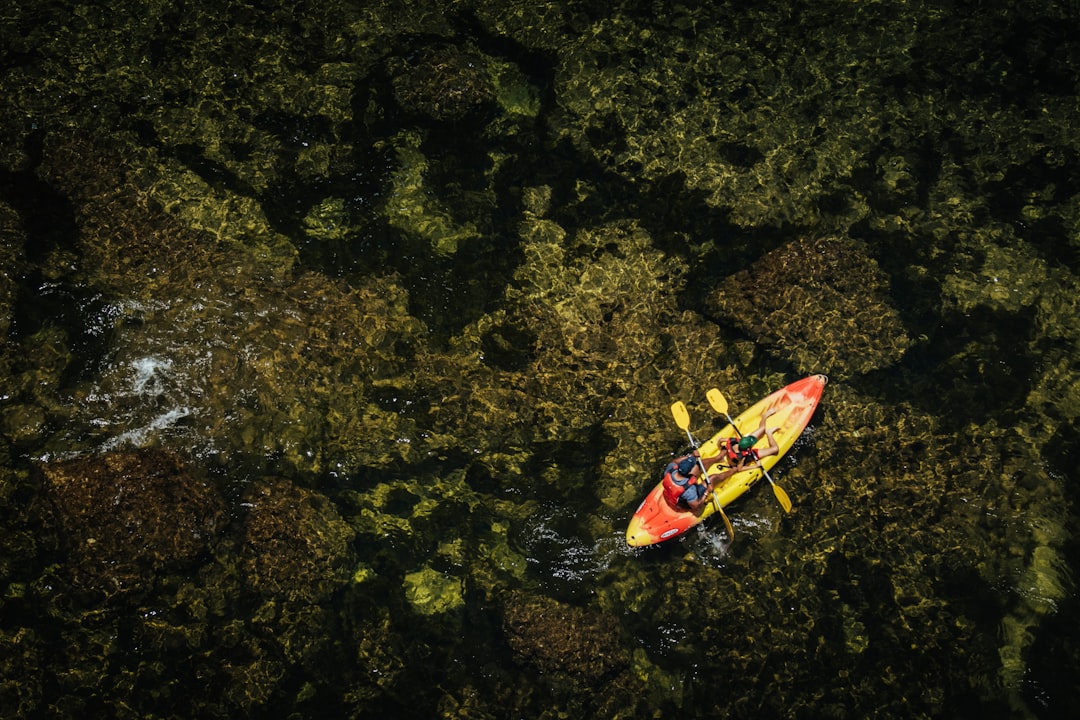 An aerial view of a kayak in the water,