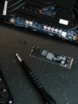 A close up of a motherboard and a pen on a table