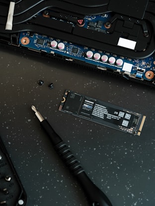 A close up of a motherboard and a pen on a table