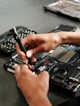 A person is working on a piece of electronics