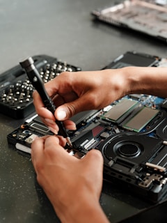 A person is working on a piece of electronics