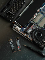 A broken laptop computer sitting on top of a table
