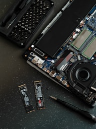 A broken laptop computer sitting on top of a table