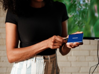 A woman standing in front of a flat screen TV