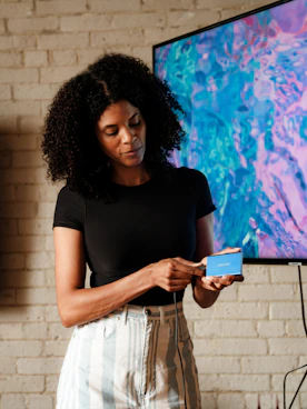 A woman standing in front of a flat screen TV