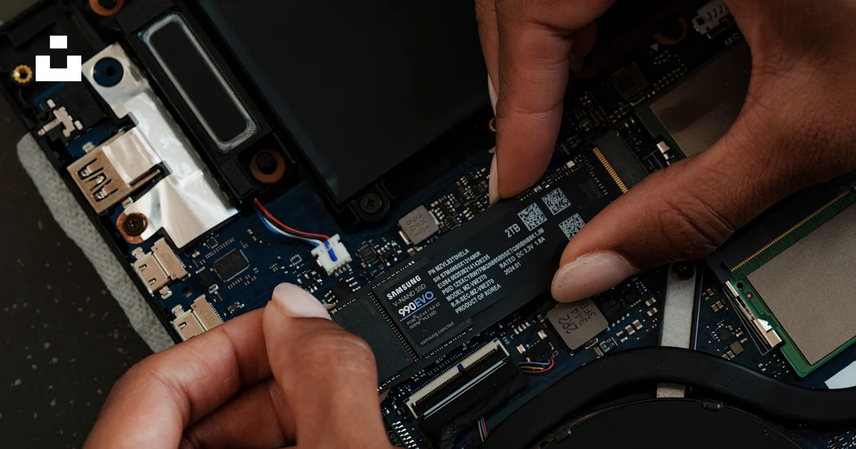 A person is removing the motherboard of a laptop photo – Free Laptop ...
