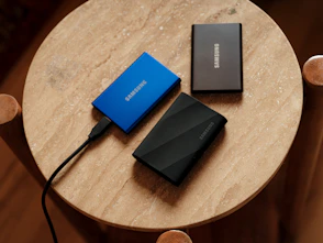 A table with a charger and a laptop on it