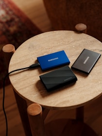 A table with two laptops and a charger on it