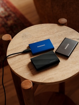 A table with two laptops and a charger on it