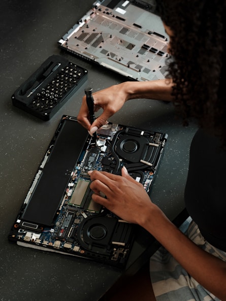 A woman is working on a laptop computer