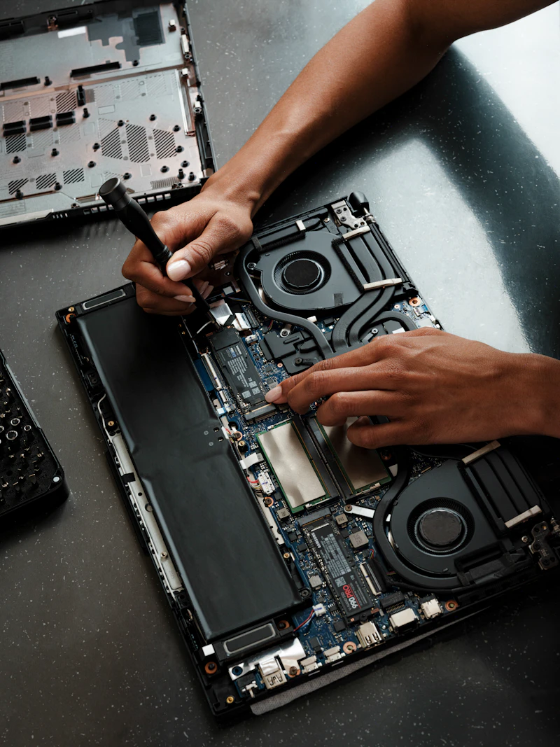 Lappytech technician repairing a laptop's internal components