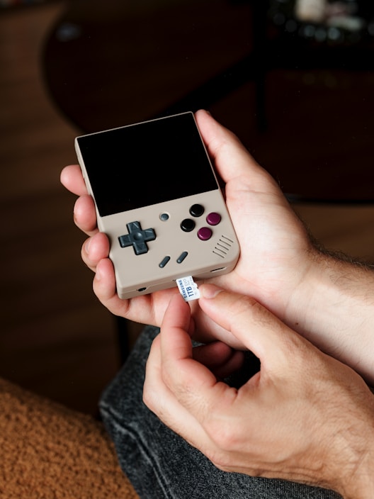 A person holding a nintendo wii game controller