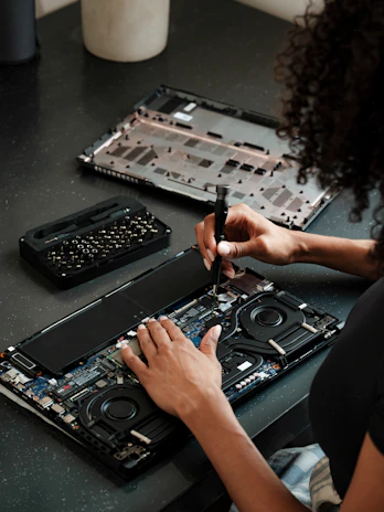 A woman sitting at a table working on a laptop