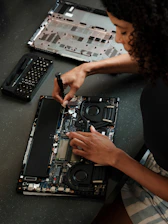 A woman sitting at a table working on a laptop