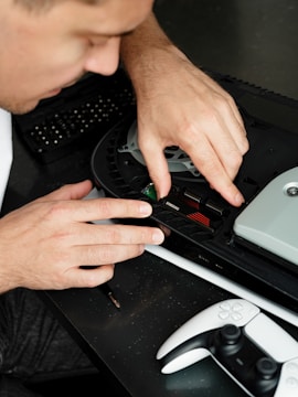 A man in a suit working on a device