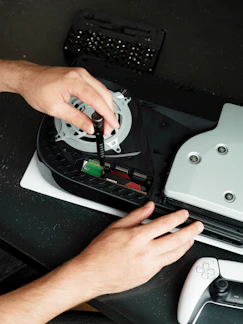 A person using a video game controller on a table