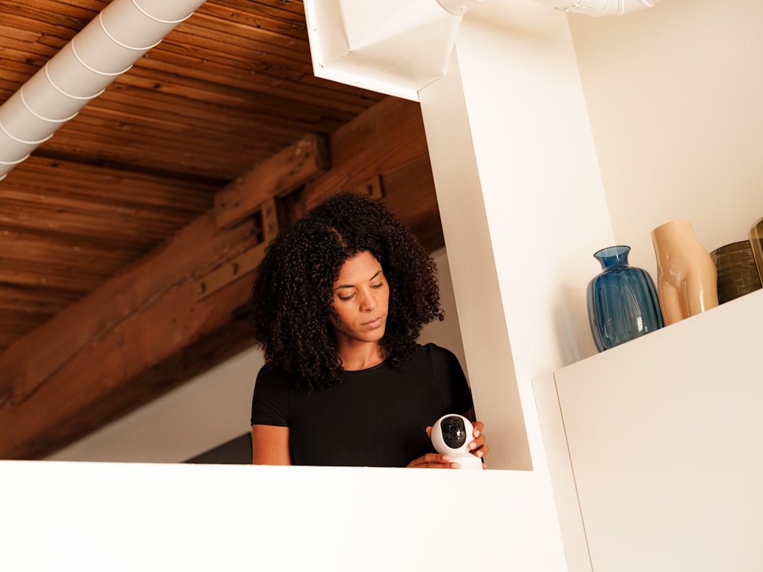 A woman standing in a room holding a camera,