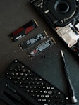 A keyboard and a pen on a table