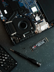 A laptop with a keyboard and a mouse on top of it