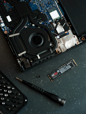 A laptop with a keyboard and a mouse on top of it