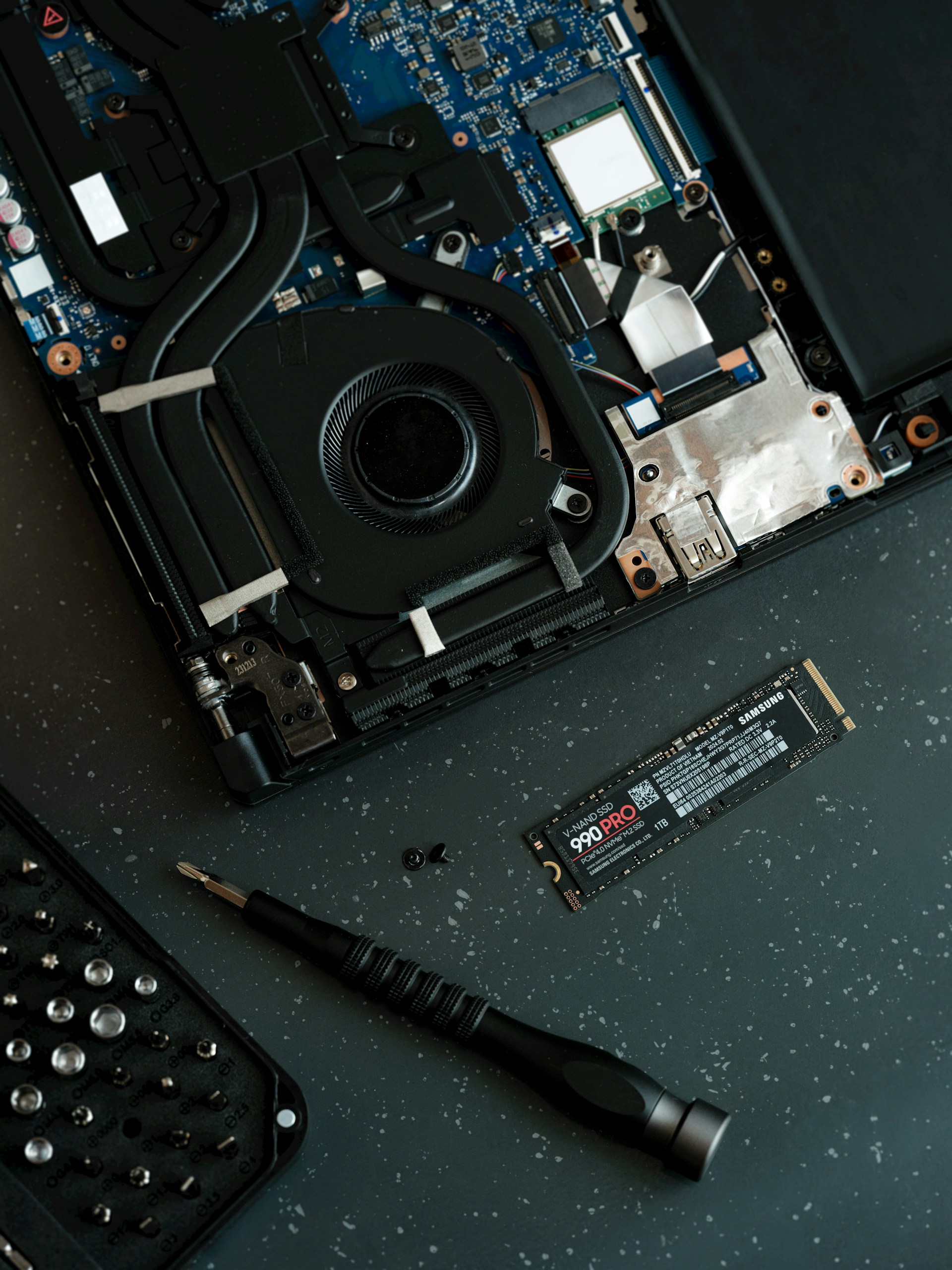 A laptop with a keyboard and a mouse on top of it