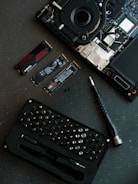 A laptop with a keyboard and a camera on top of it