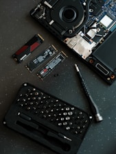 A laptop with a keyboard and a camera on top of it