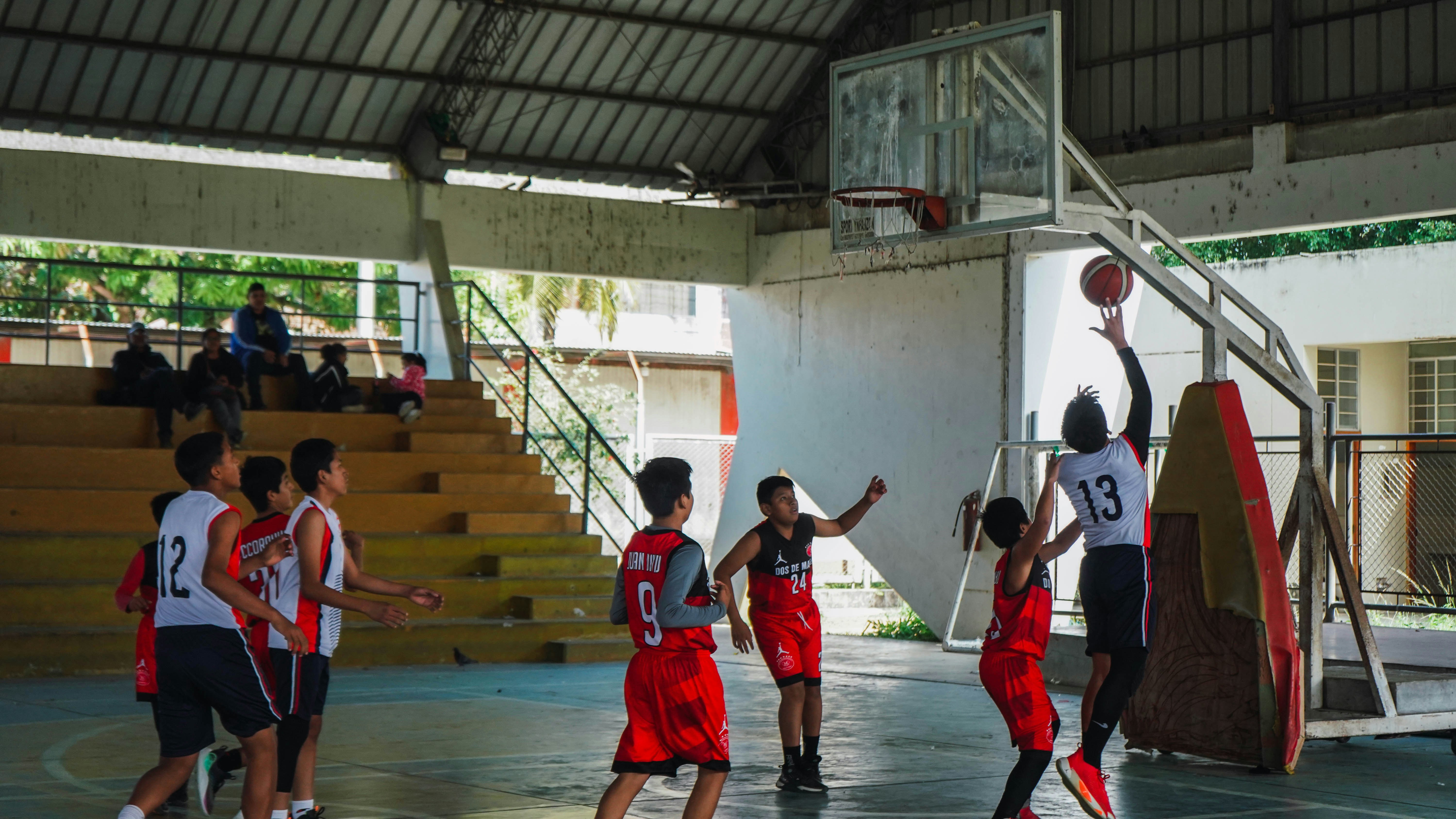 A group of young men playing a game of basketball