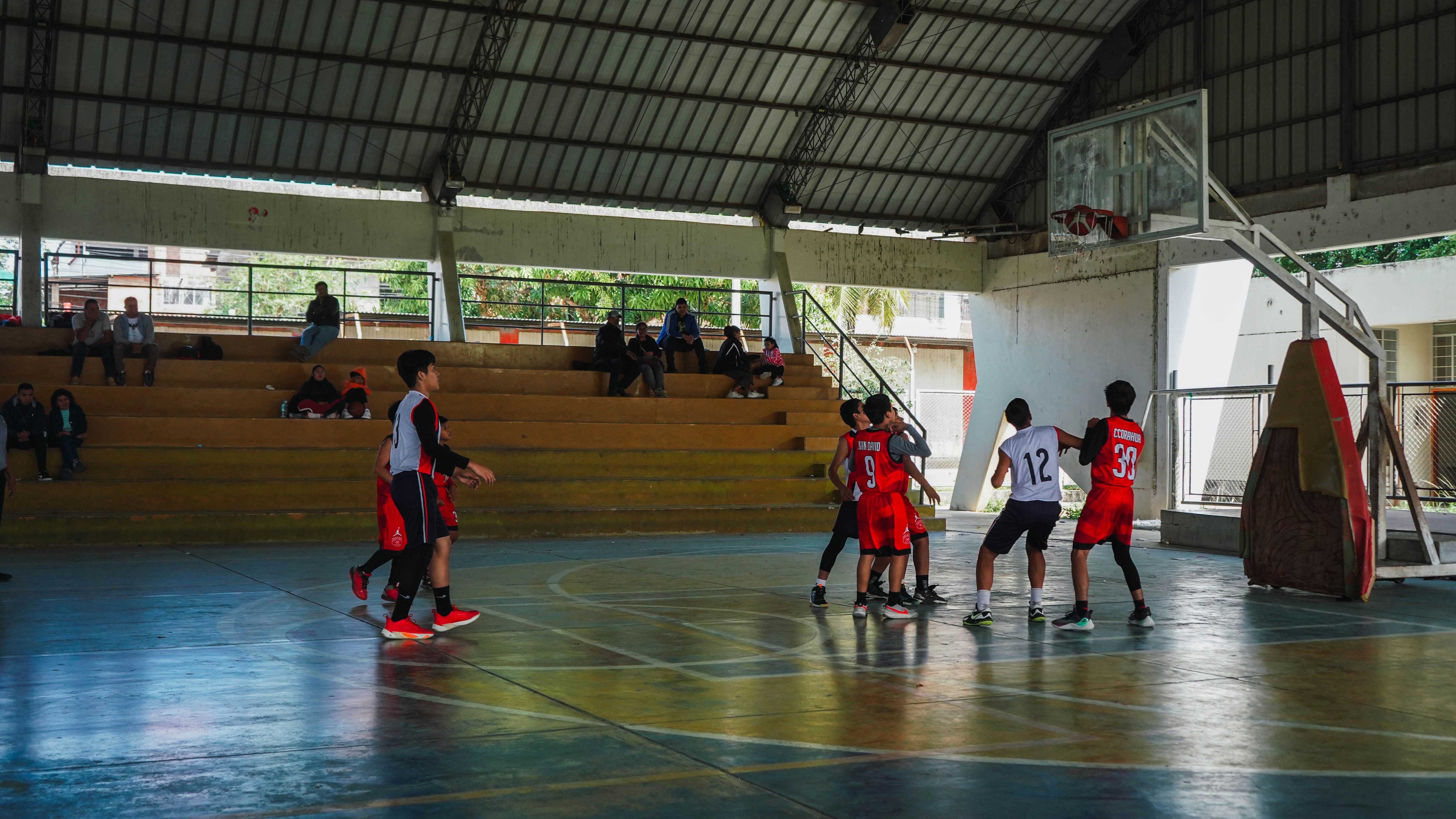 A group of young men playing a game of basketball