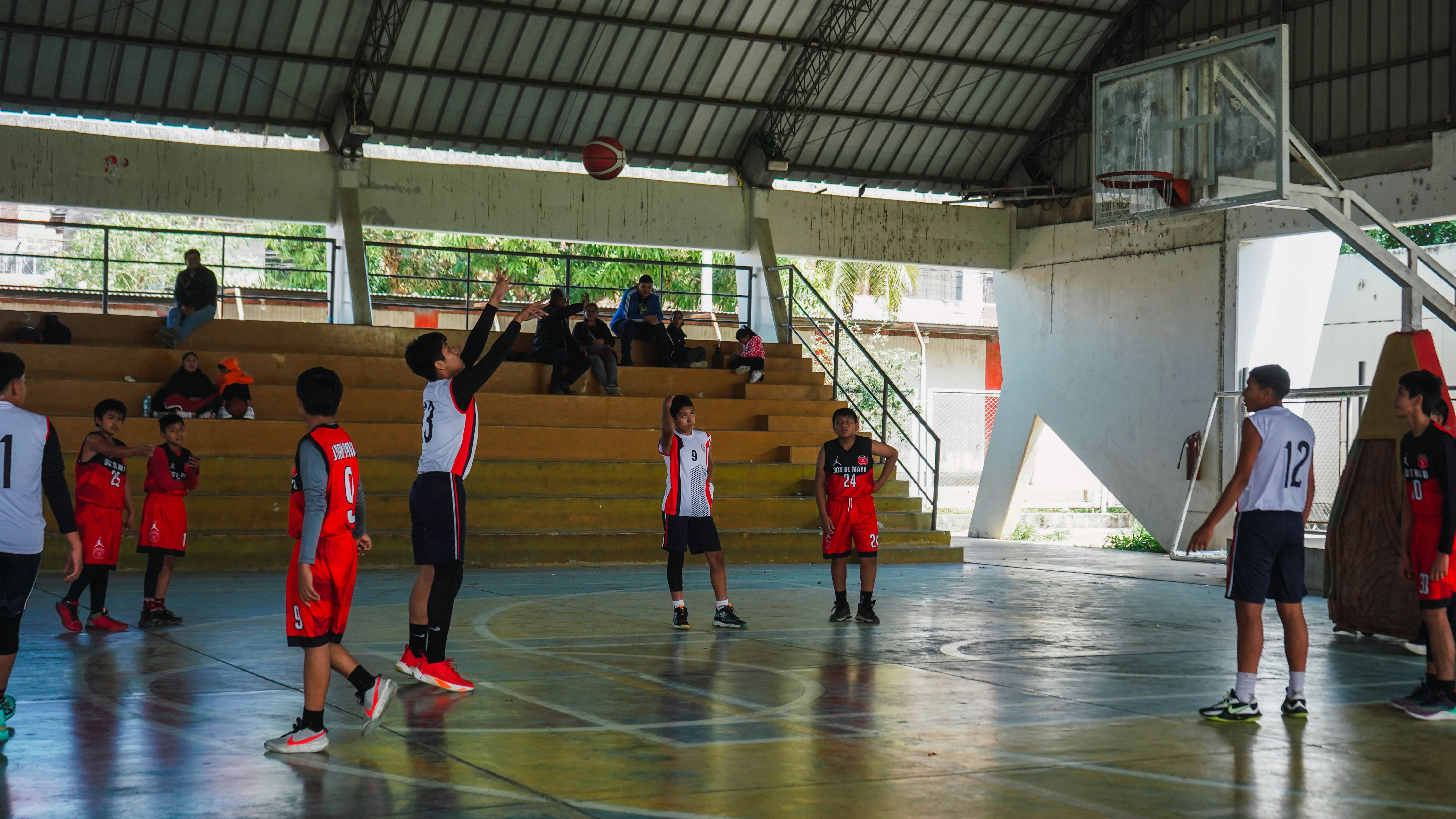 A group of young men standing on top of a basketball court