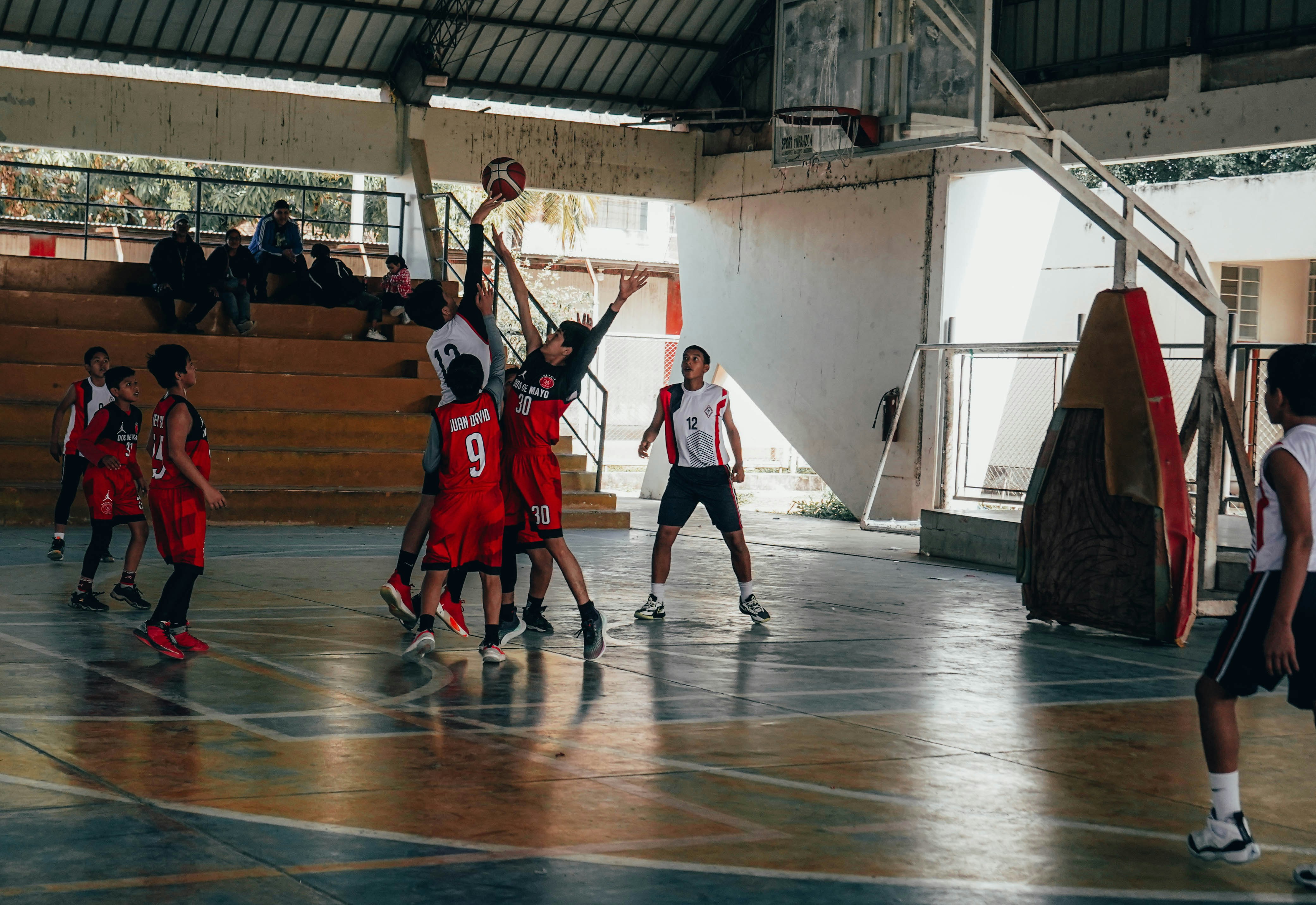 A group of young men playing a game of basketball