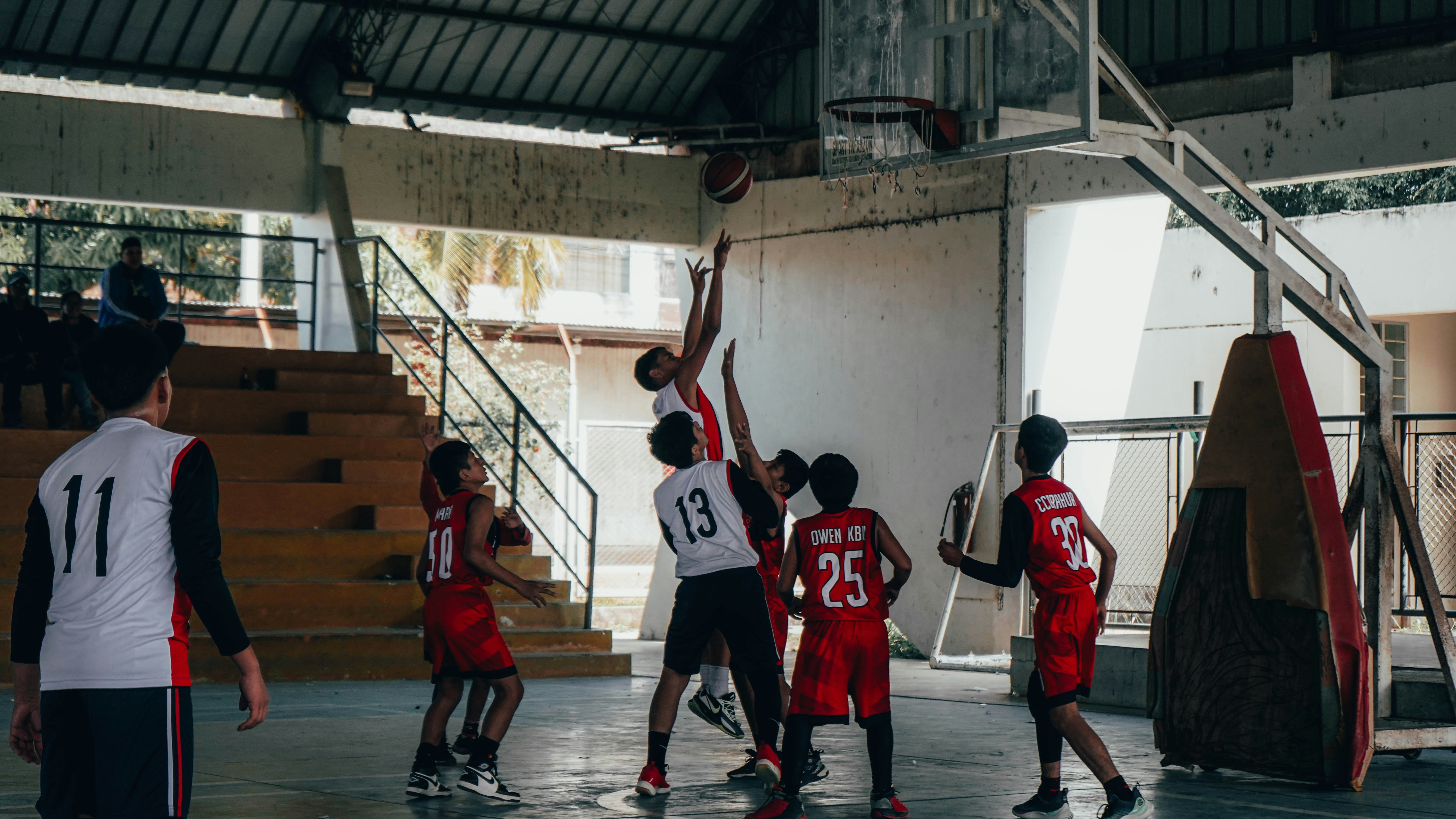A group of young men playing a game of basketball