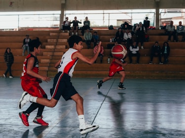 A group of young men playing a game of basketball