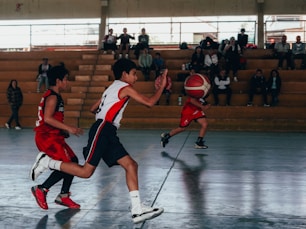 A group of young men playing a game of basketball
