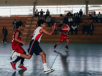 A group of young men playing a game of basketball