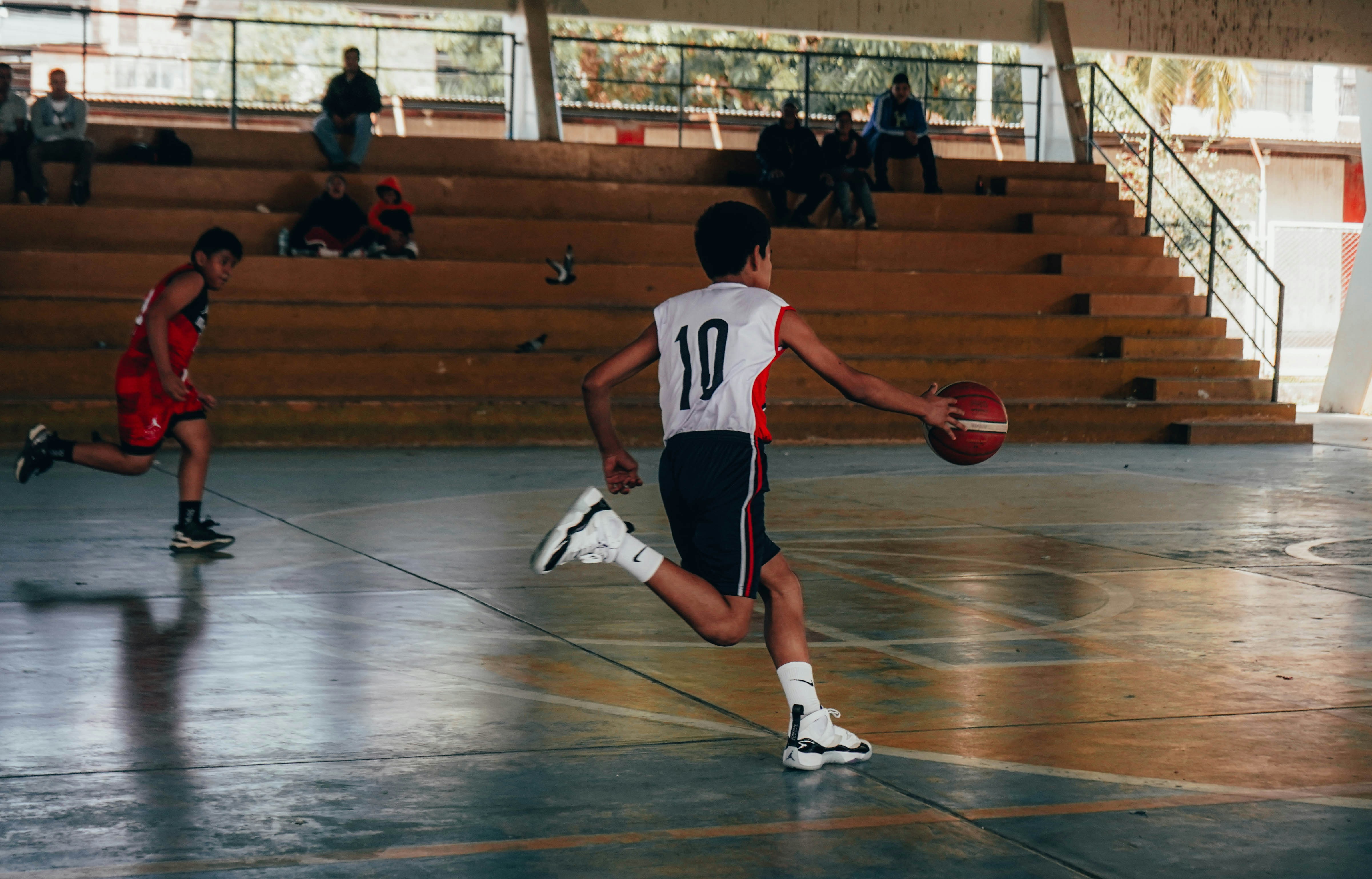 A group of young men playing a game of basketball