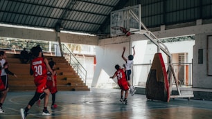 A group of young men playing a game of basketball