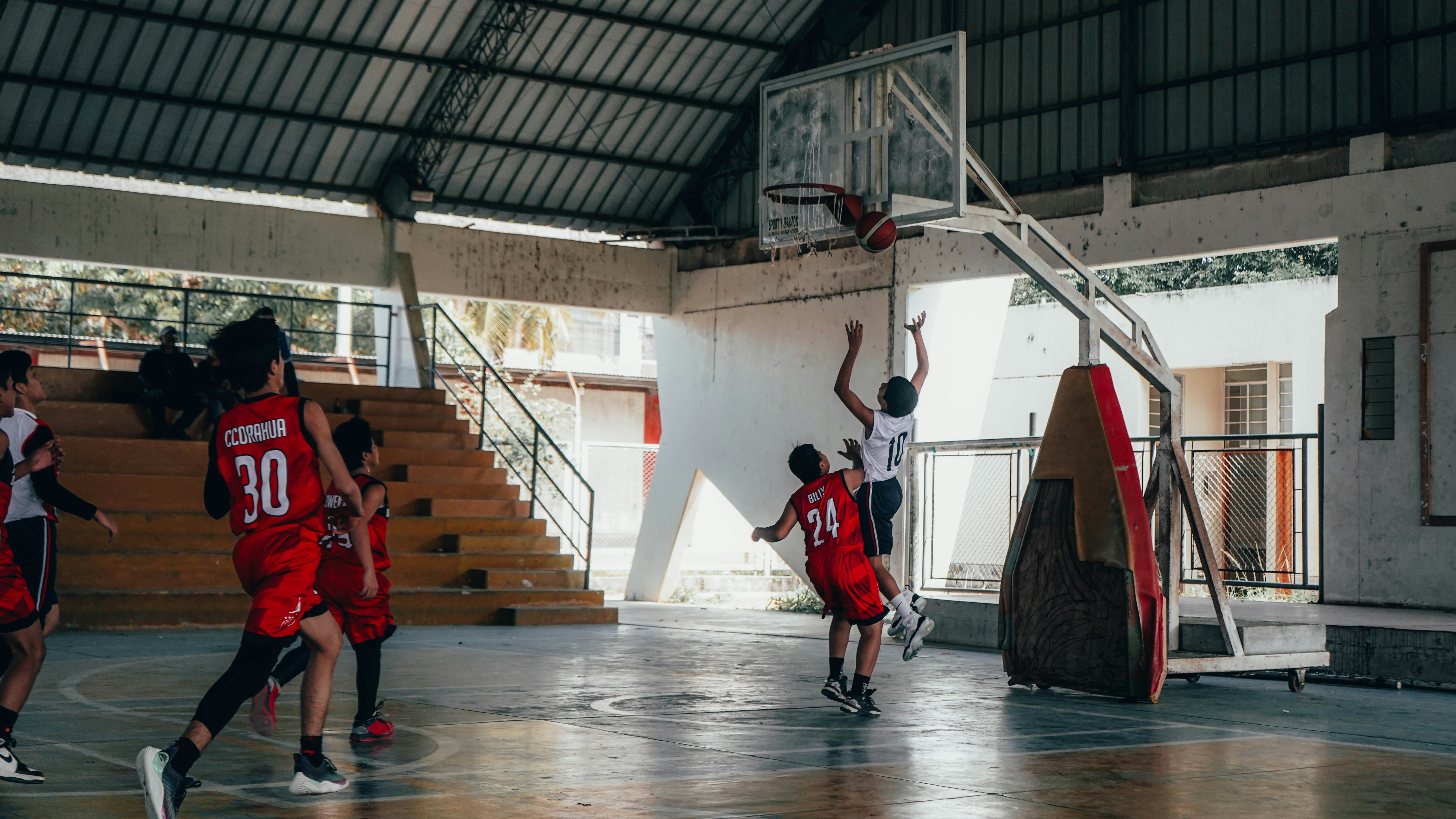 A group of young men playing a game of basketball