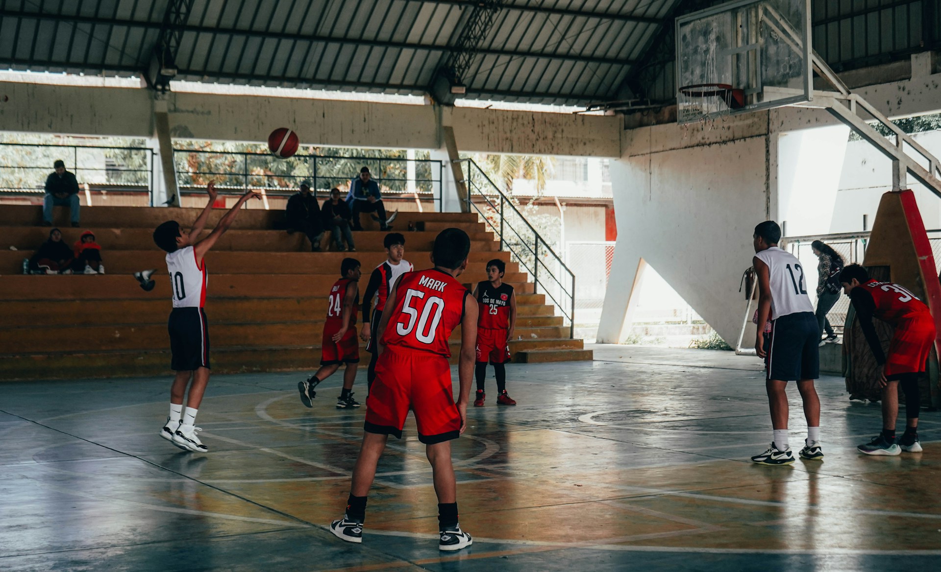 A group of young men playing a game of basketball