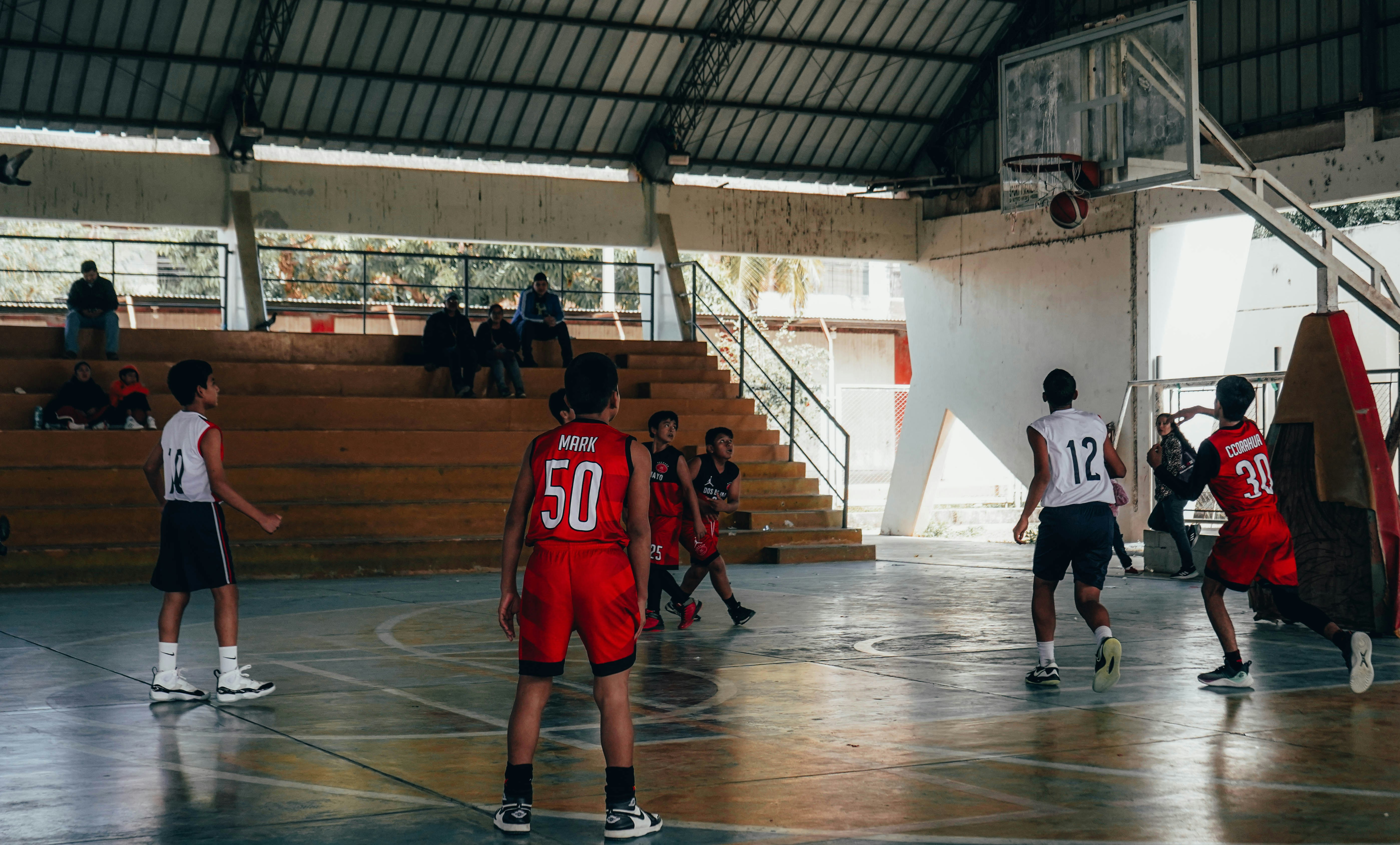 A group of young men playing a game of basketball