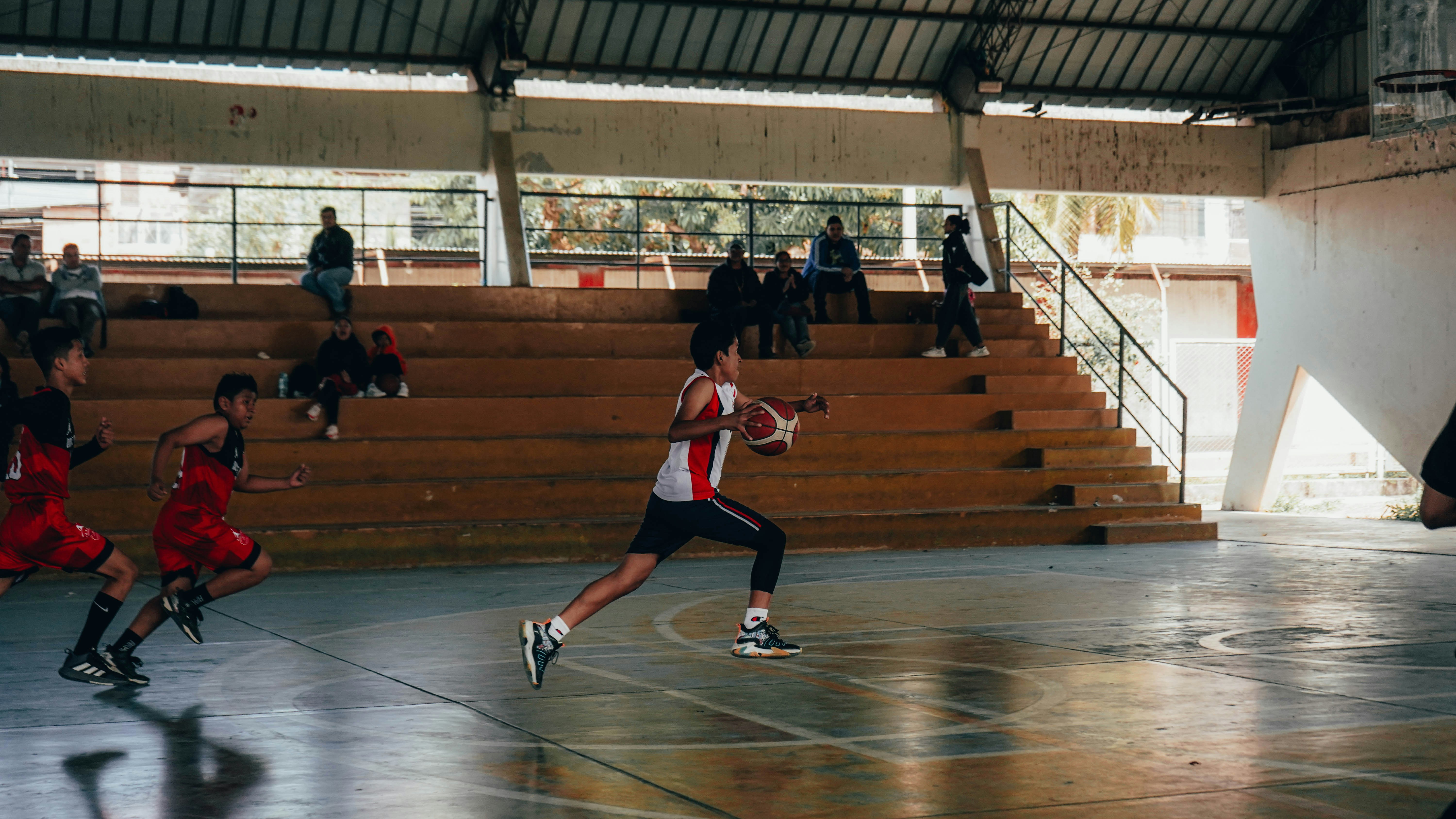 A group of young men playing a game of basketball