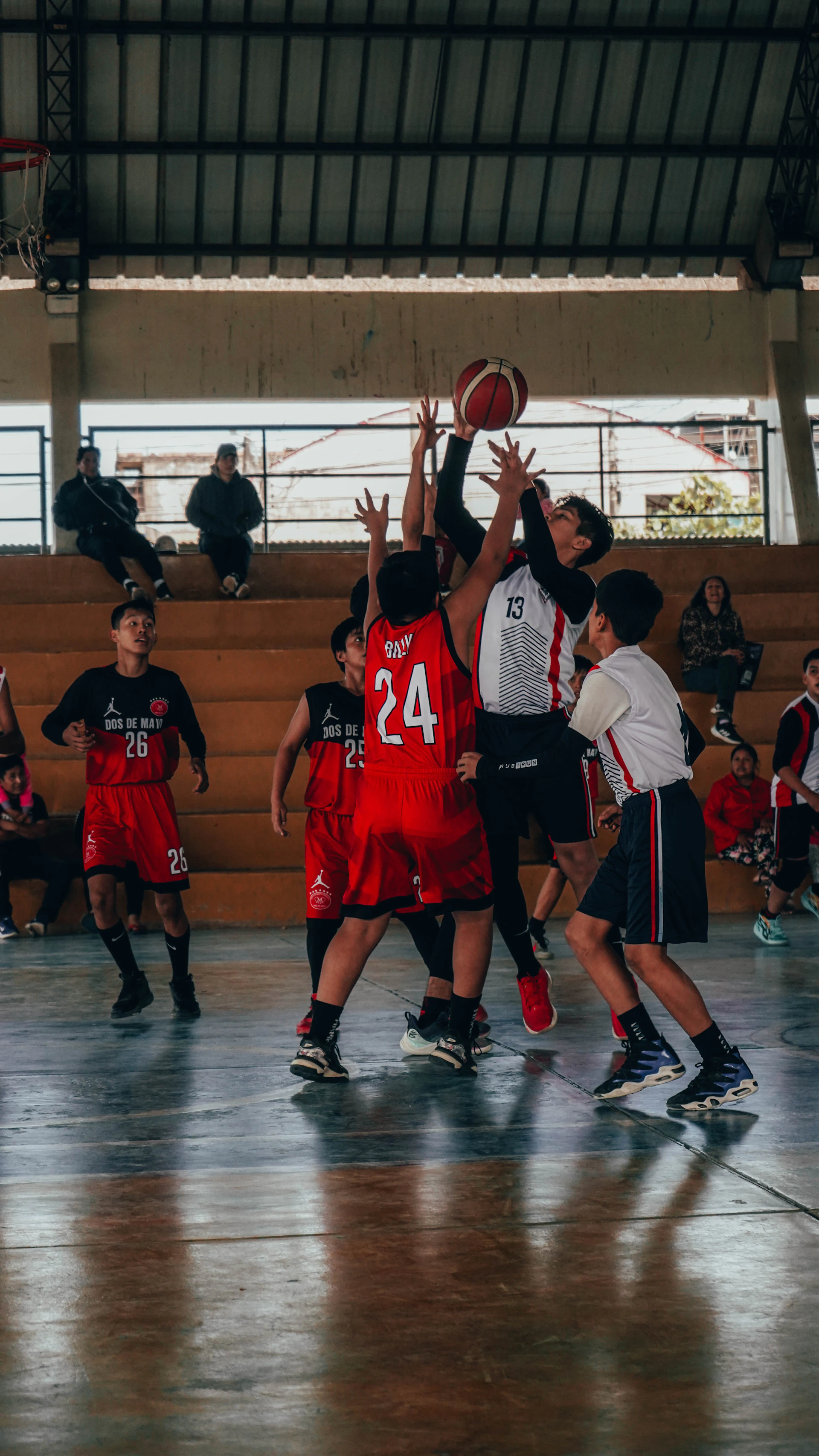A group of young men playing a game of basketball